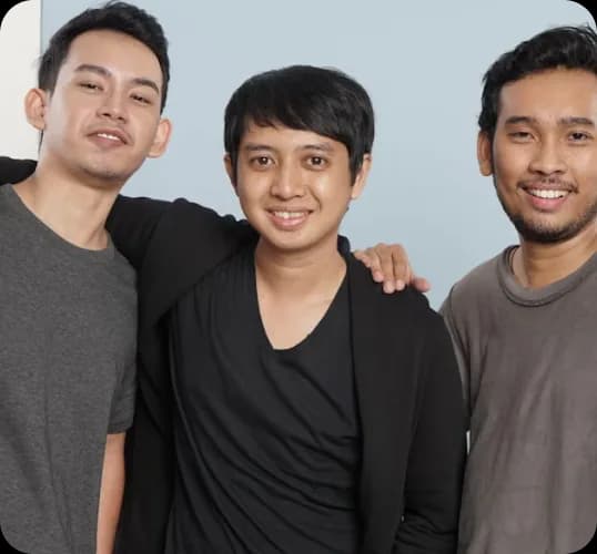 Three smiling young men standing together